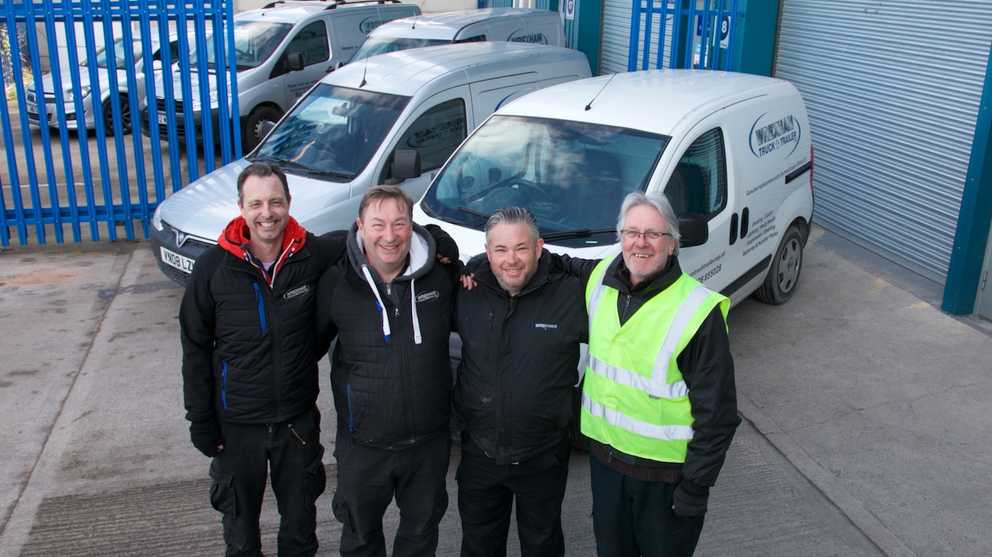 Four men huddled together